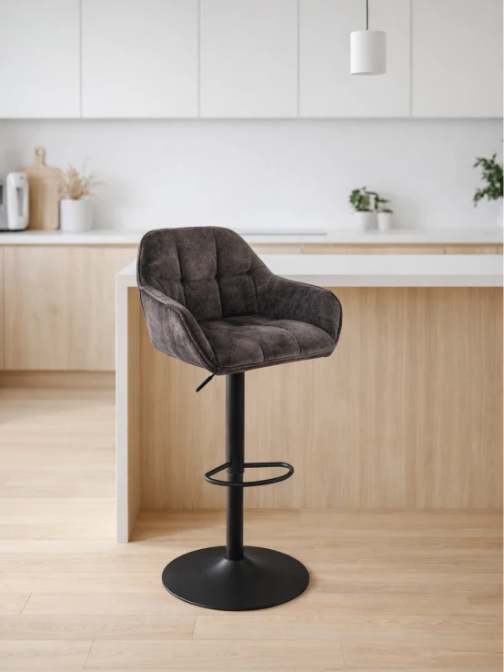 Dark grey upholstered bar stool at a kitchen island