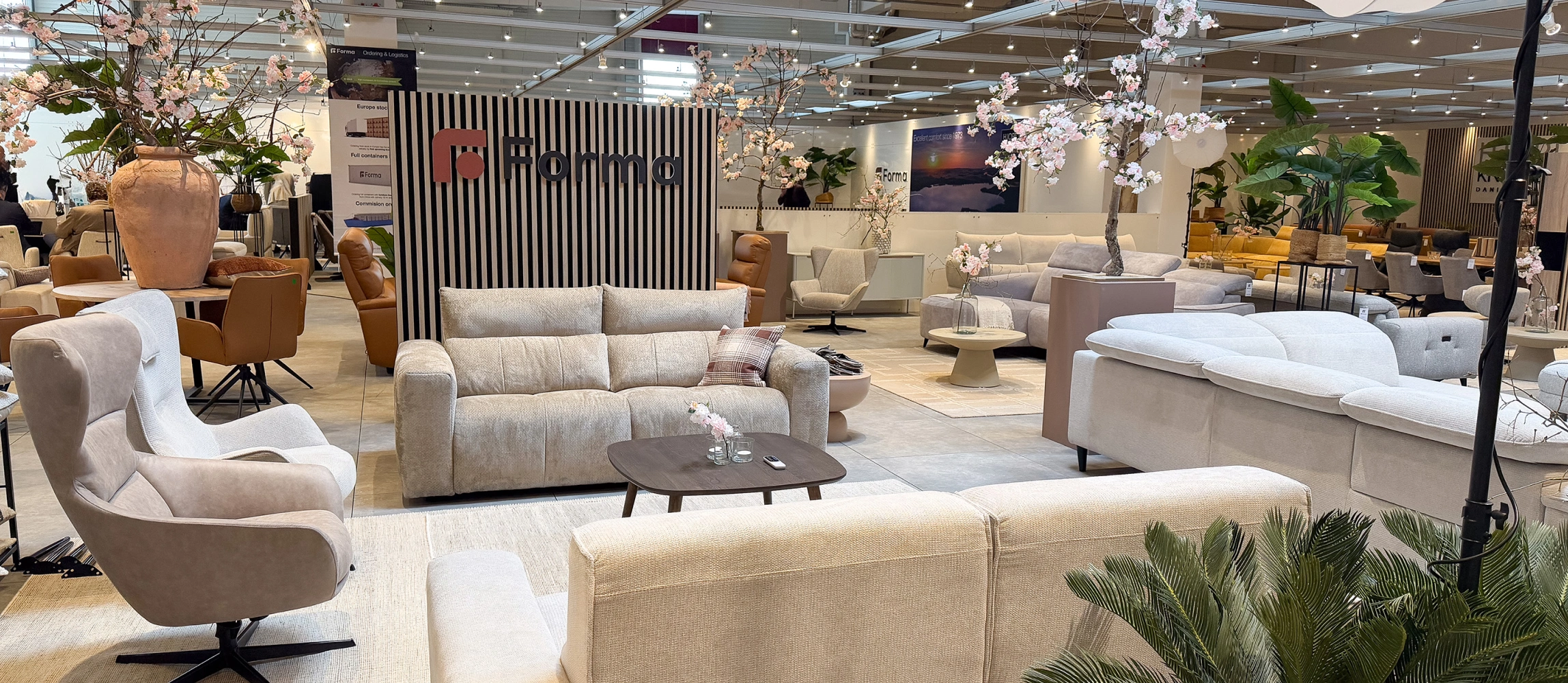 Forma furniture fair stand with cream armchairs and sofas